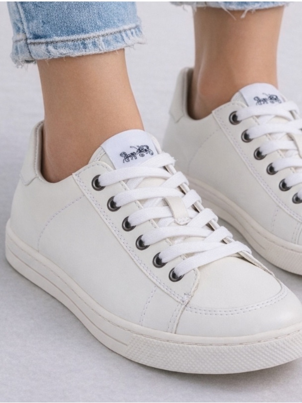 Women’s Coach Porter white leather low top sneakers with a lace-up design